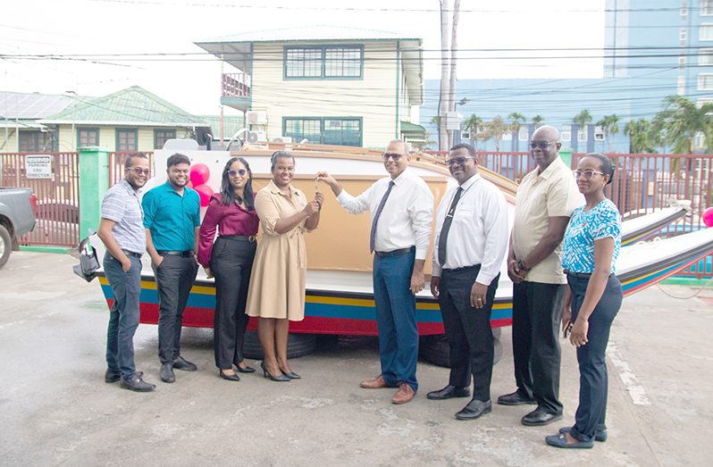 Regional Health Officer (RHO) of Region Three Dr Erica Forte receives the key for one of the boats from Minister of Health, Dr Frank Anthony, at the simple handing-over ceremony
