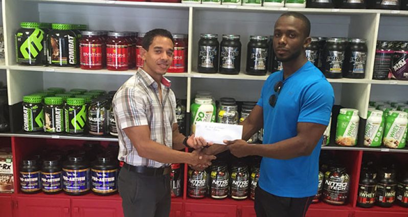 Owner/Proprietor of Fitness Express Jamie McDonald hands over a sponsorship cheque to GAPLF PRO Paul Adams.