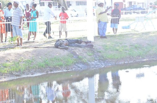 The unidentified body after it was fished out of the Church Street canal by the police on Thursday afternoon. [Daniel Haynes photo]