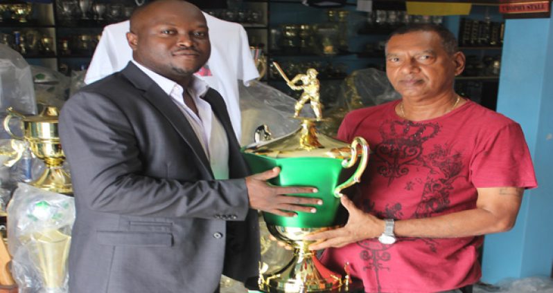 James Bond of 007 Promotions (left) collects the President’s trophy from Ramesh Sunich of Trophy Stall.