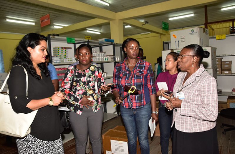 Chairperson of the Parliamentary Sectoral Committee on Social Services, Dr. Vindhya Persaud interacting with the Acting Pharmacy Manager Yvonne Bullen in the presence of the media and parliamentary staff