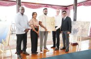 President Dr. Mohamed Irfaan Ali receiving the donations from Hieronymus and Shameena Wosten, alongside Minister of Home Affairs Robeson Benn, and Attorney-General Anil Nandlall