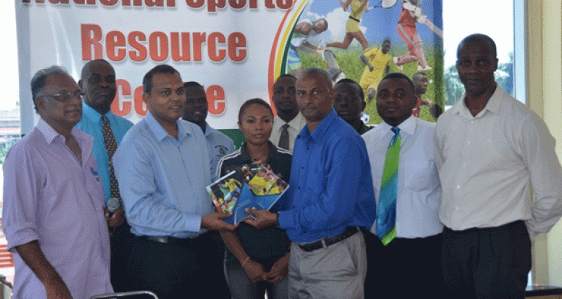 Roy McArthur presents two of the books to Dr Frank Anthony (2nd left), in the presence of GFRC president Alfred King (right), Director of Sport Neil Kumar (left), and other referees attached to the GFRC.