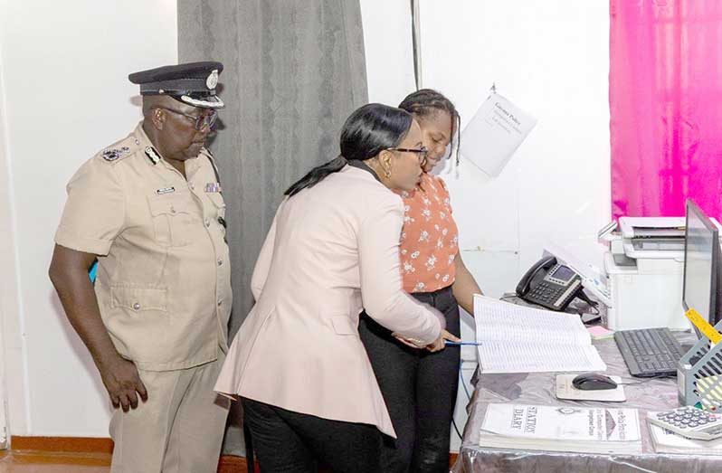 Home Affairs Minister Oneidge Walrond and Deputy Commissioner ‘Operations’ Errol Watts examining daily operations