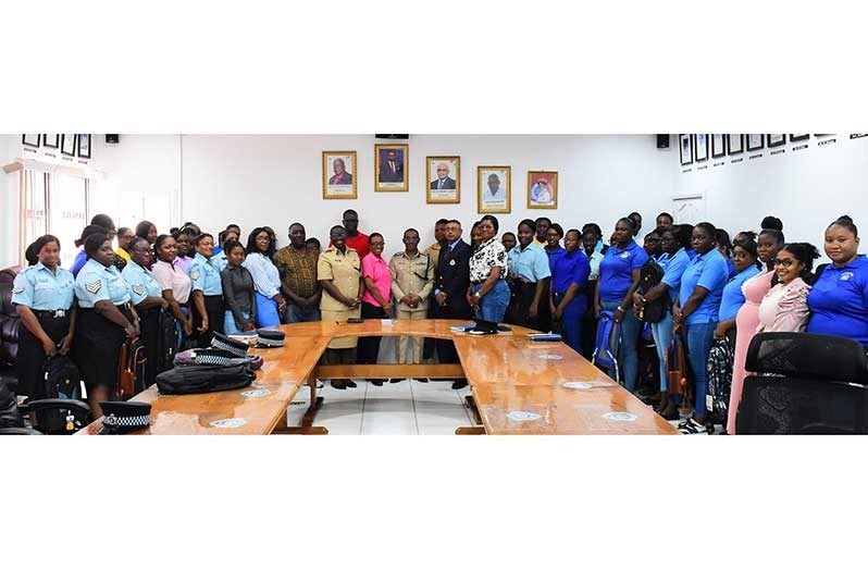 Commissioner of Police (ag) Clifton Hicken (centre) flanked by senior officers along with ranks that benefitted from the backpacks and school supplies distribution as part of his ongoing ‘Back to School’ drive