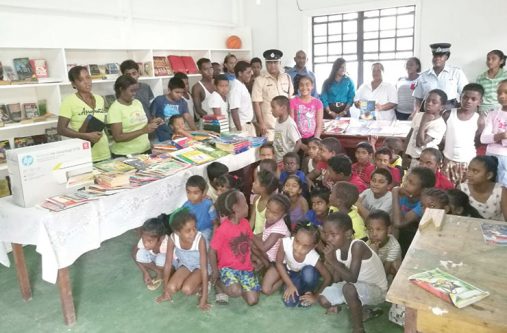 Divisional Commander, Ravindranauth Budhram, with parents and children at the Byderabo Multi-Purpose Complex