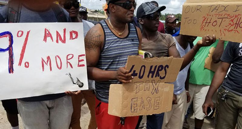 Workers picketing for increased wages and other benefits in front of the Bosai compound in Linden