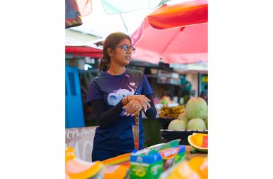 Twenty-two-year-old Radha Danpat sells pumpkin seeds at Bourda Market, continuing her family’s long-standing market tradition (Samuel Maughn photo).