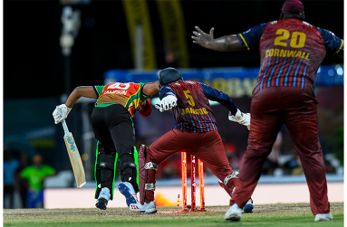 Amir Jangoo and Rahkeem Cornwall watch as Quentin Sampson is bowled