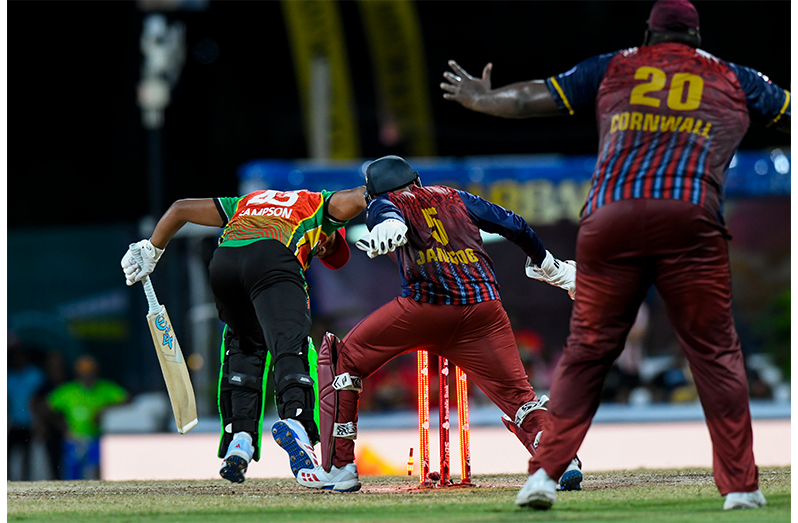 Amir Jangoo and Rahkeem Cornwall watch as Quentin Sampson is bowled