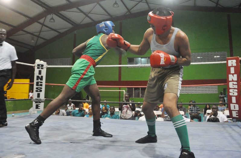 Republican Thadius Perry (right) connects with an overhand right to GDF’s Wilbert James during their light heavyweight contest at the National Gymnasium on Friday night.
