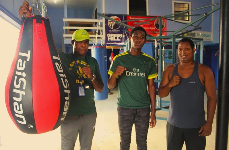 Herve Charlemagne (centre) flanked by Coach Conrad Fredericks (left) and Coach Hilary Dalson (right) at the Vigie Boxing Gym in St. Lucia