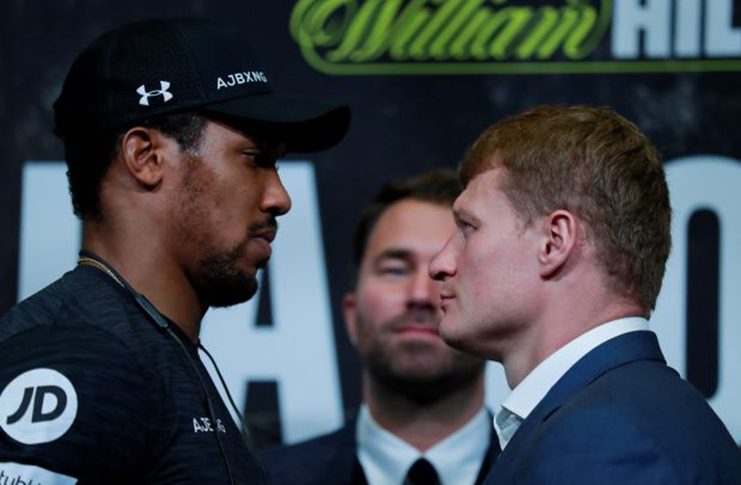 Anthony Joshua and Alexander Povetkin go head-to-head as promoter Eddie Hearn looks on. (Action Images via Reuters/Andrew Couldridge)