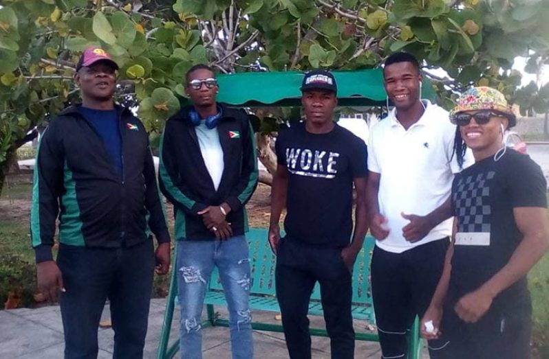 National coach Terrence Poole at left with the four local boxers in Cuba .