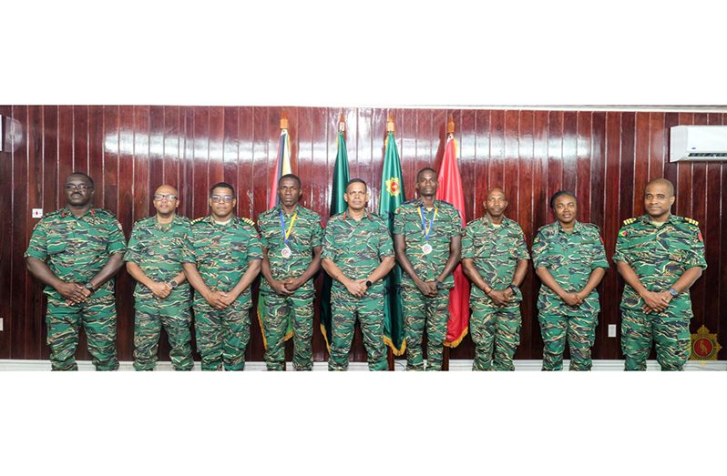 Brigadier Omar Khan (Centre) with Sergeant Desmond Amsterdam and Petty Officer Colin Lewis, as well as other top ranks of the GDF