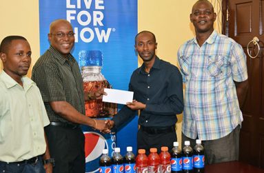 L-R, GBA Youth coach Seibert Blake watches on as GBA president Steve Ninvalle gladly accepts the sponsorship cheque from DDL’s brand executive Larry Wills. GBA TD Terrence Poole also looks on. (Samuel Maughn photo)