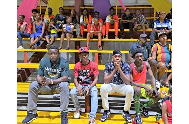 Guyana's only Olympic Medalist Mike Parris (2nd from left sitting) was among those who watched the action on Saturday night (Sean Devers photo)
