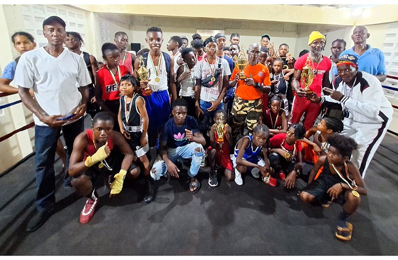 Medal-winning boxers and their coaches with their trophies and medals (Sean Devers photo)