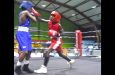 Mordino Maasie of Surname pounds away on Guyana's Jaqwan Milo before his corner threw in the towel in the final round