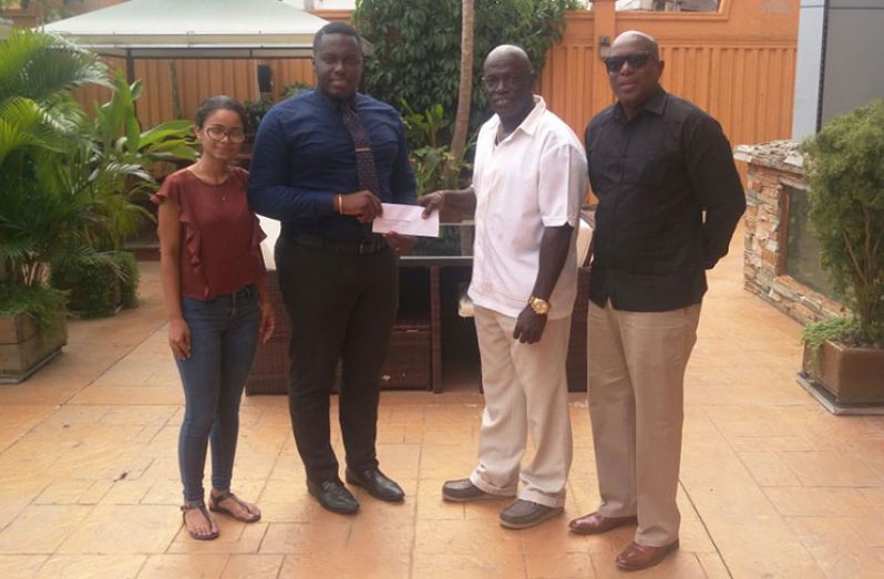 Here, Tower Suites Events, Food and Beverage Manager Neilson McKenzie (second from left) hands over sponsorship check to head of McDonald Promotions Alford McDonald. Looking on are Tower Suites Operations Manager Shivani Sawh and GBA president Steve Ninvalle.