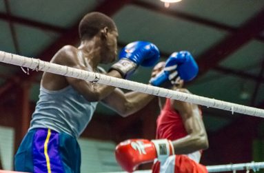 GDF’s Colin `Superman’ Lewis (right) storms forward with a flurry of combinations to the body and head of VBG’s Aubrey Moore in their junior welterweight contest on Saturday night (Photo by Delano Williams).