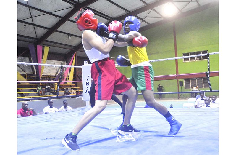 GDF’s Joseph Gardener (left) scores with crunching left uppercut to the chin of Police’s Joshua Khan as the boxers went toe-to-toe at the National Gymnasium on Saturday night (Sean Devers photo)