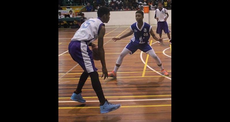 Kareem Boyle with ball sizing up defender