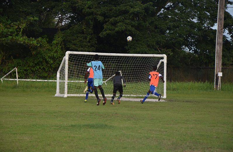 Tyrice Dennis’ chip leaves the Chase goalkeeper scrambling back to the goal. (Stephan Sookram photo)