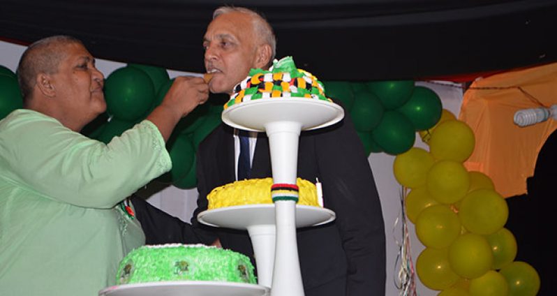 Member of Parliament Ms Rajcoomarie Bancroft sticks the region’s anniversary cake with Minister Bulkan