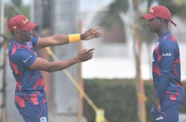 LEADING THE WAY: Veteran all-rounder Dwayne Bravo makes a point to uncapped off-spinner Kevin Sinclair. (Photo courtesy CWI Media)