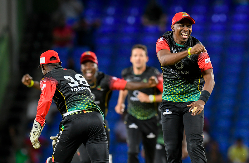 Dwayne Bravo (R) of St. Kitts & Nevis Patriots celebrates the dismissal of Johnson Charles of Barbados Royals during the 2021 Hero Caribbean Premier League match 2 between Barbados Royals and St. Kitts & Nevis Patriots at Warner Park Sporting Complex on August 26, 2021 in Basseterre, St Kitts, Saint Kitts and Nevis. (Photo by Randy Brooks - CPL T20/Getty Images)"