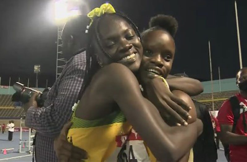 Brianna Lyston (left) embraces Tia Clayton following Jamaica’s world record in the girls Under-20 sprint relay.