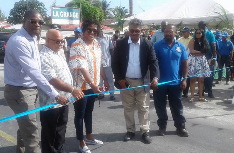 Minister within the Ministry of Public Infrastructure, Annette Ferguson, (third left) cuts the ribbon at the ceremonial opening of the upgraded Bagotville bridge on Saturday. Also in photo are Minister of Public Infrastructure, David Patterson; REO, Region Three, Denis Jaikaran and other officials (Regional Administration- Region Three photo)