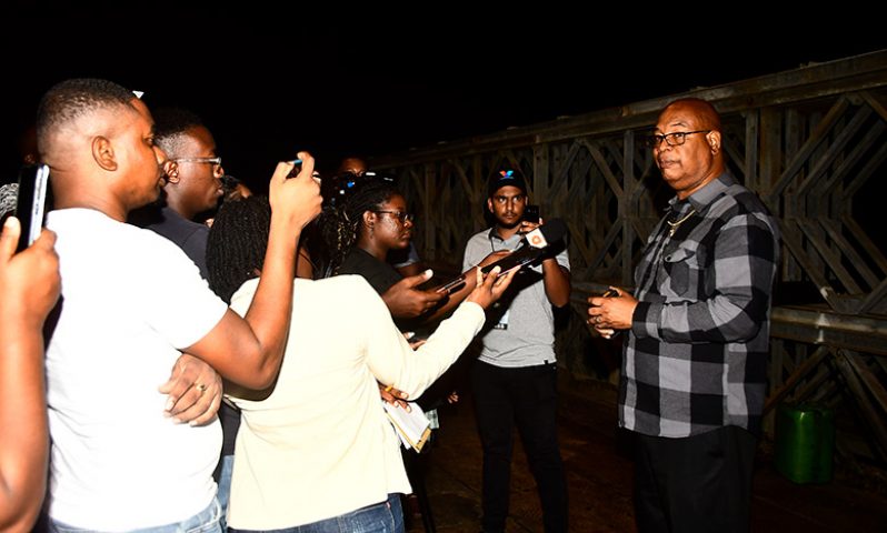 Public Works Minister Juan Edghill engages the media corps on Monday evening for the re-opening of the Demerara Harbour Bridge (Adrian Narine photo)