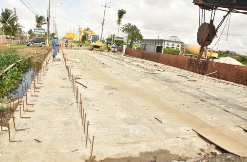 Construction staff hard at work on Monday on the Liliendaal Bridge to meet that June month-end deadline