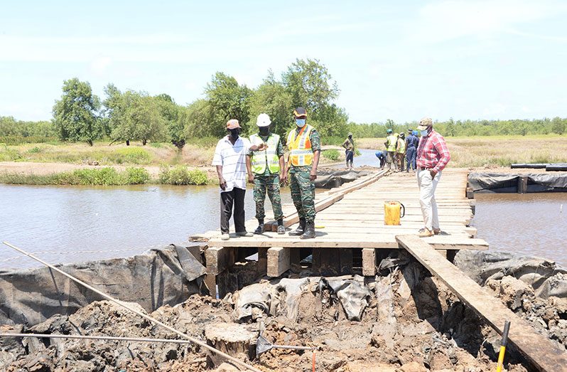 (Third from left) Brigadier (ret’d) Gary Beaton and Staff Officer One- Plans and Supervision, LT Col Kennard Liverpool during the inspection of the Tappin Dam Bridge