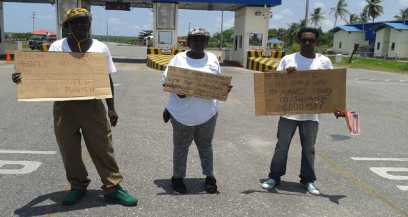 Members of the Justice for the Unjust protesting Friday at the entrance to the Berbice Bridge