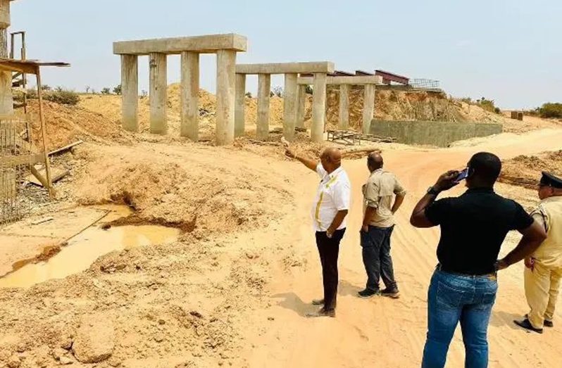 Minister of Public Works Juan Edghill, the engineering team and contractor inspecting works on the Pirara bridge