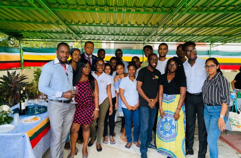 At the back: Guyana’s Ambassador to Cuba, Halim Majeed with Guyanese students in Cuba at the ceremony