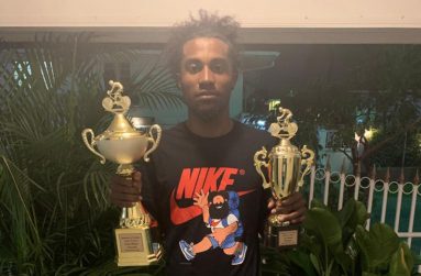 Guyana’s current top cyclist Briton John poses with his spoils from the Independence Three-Stage race.