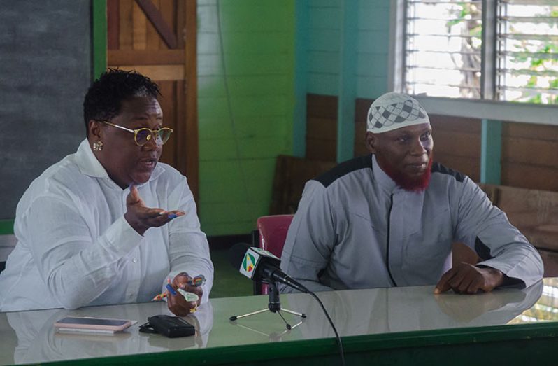 Minister of Youth Affairs, Simona Broomes, with the Imam of the Alexander Village Masjid addressing Muslim brothers and sisters