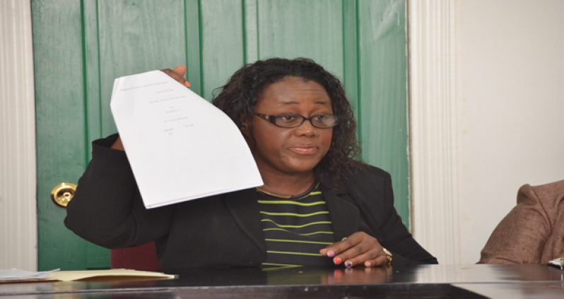 Minister within the Ministry of Social Protection Simona Broomes holds a copy of recommendations put forward to BOSAI Minerals by her ministry (Photo by Delano Williams)