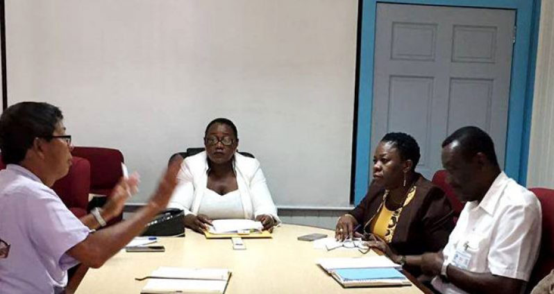 Minister Broomes, centre, in discussion with GGMC Chairman Stanley Ming (left), MARAD Director Claudette Rogers (second right) and Harbour Master Michael Tennet (right)