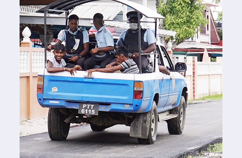 Brothers, Mohammed Fiaz Edun and Mohammed Saheer Edun were placed in the back of a police vehicle and escorted from their house (Elvin Croker photos)