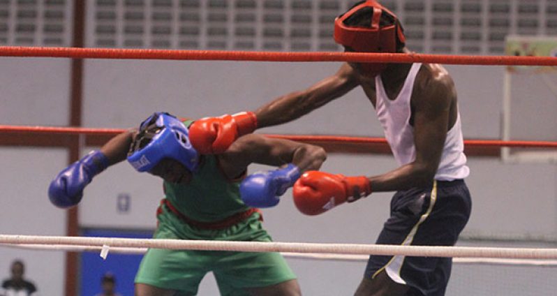 Republican gym’s Bryan Leitch (right) connects to the head of a ducking Ryan Roberts (GDF) during the final of the GBA’s National Intermediate heavyweight final at the National Gymnasium on Sunday night.
