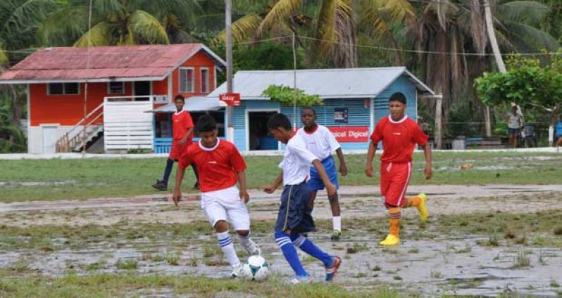 Part of the action between eventual victors St Cuthbert’s Mission (red) and Achievers Academy, which was contested last Sunday at the St Cuthbert’s Mission ground.