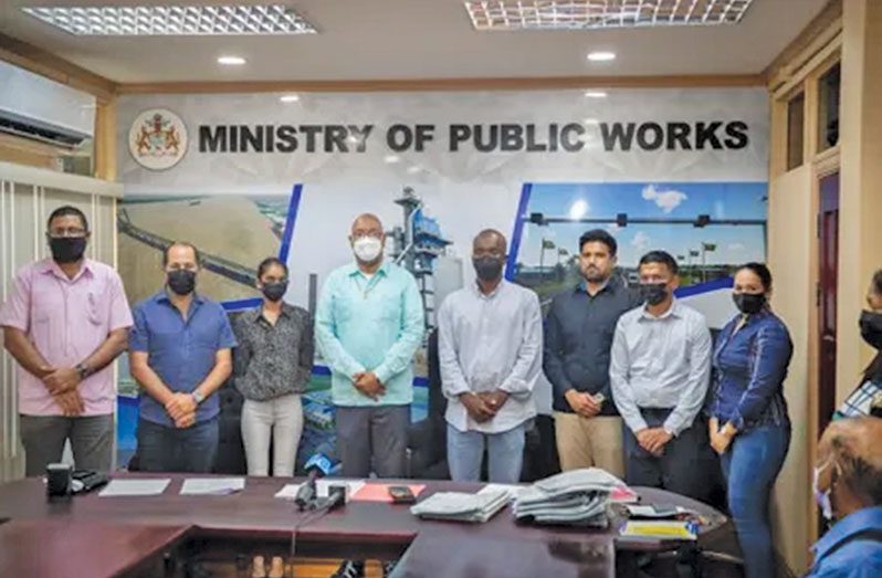 Public Works Minister, Juan Edghill and Permanent Secretary, Vladim Persaud with the contractors during the signing of the contracts