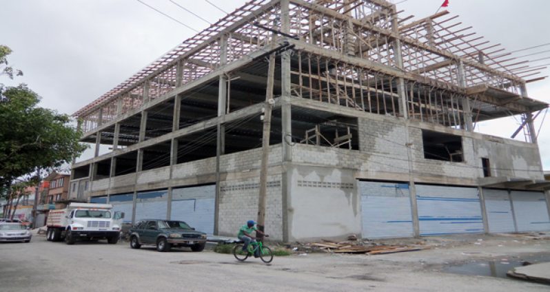 An M&CC truck seizing concrete blocks that were stored on the parapet, while construction has been halted since the city engineers department gave no approval for construction of the building