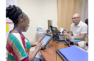 A Bureau of Statistics enumerator engages a business owner using a tablet-based questionnaire as part of the National Economic Survey, which begins November 10 across Regions Two, Three, Four, and Six