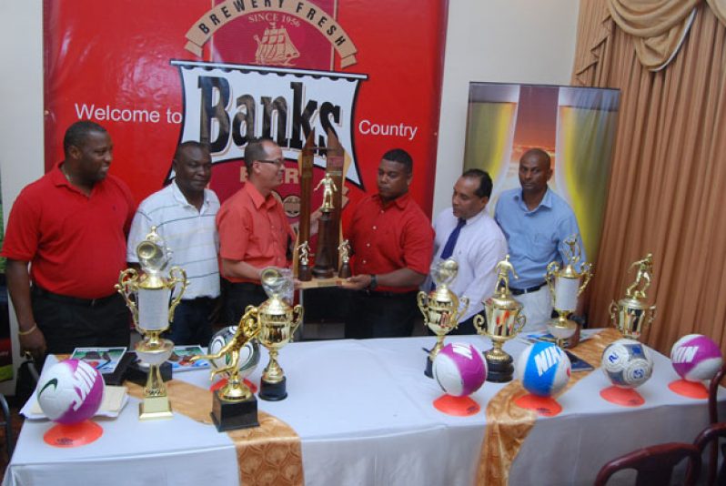 Banks Beer Brand Manager Brian Choo-Hen (3rd from left) hands over the first place trophy to GFA president Vernon Burnett, while from left Mortimer Stewart, Troy Peters, Ivan Persaud and Roy McArthur look on appreciatively. (Photo by Sonell Nelson)